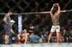 Jun 7, 2014; Albuquerque, NM, USA; Benson Henderson (red) celebrates his victory over Rustam Khabilov (blue) after their lightweight bout during UFC Fight Night 42 at Tingley Coliseum. Henderson won via fourth round submission. Mandatory Credit: Joe Campo