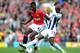 MANCHESTER, ENGLAND - MARCH 11: Paul Pogba of Manchester United is challenged by Marc-Antoine Fortune of West Bromwich Albionduring the Barclays Premier League match between Manchester United and West Bromwich Albion at Old Trafford on March 11, 2012 in