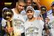 CLEVELAND - JUNE 14: Tim Duncan #21 and Finals MVP Tony Parker #9 of the San Antonio Spurs celebrate with the Larry O'Brien Trophy and MVP Trophy after they won the NBA Championship with their 83-82 win against the Cleveland Cavaliers in Game Four of the