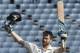 Jimmy Neesham celebrates his century.