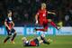 PARIS, FRANCE - MARCH 12: Eren Derdiyok of Bayer Leverkusen jumps a tackle from Christophe Jallet of Paris Saint-Germain during the UEFA Champions League Round of 16 second leg match between Paris Saint-Germain FC and Bayer Leverkusen at Parc des Princes