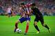 MADRID, SPAIN - APRIL 09: Juanfran of Club Atletico de Madrid and Pedro of Barcelona fight for the ball during the UEFA Champions League Quarter Final second leg match between Club Atletico de Madrid and FC Barcelona at Vicente Calderon Stadium on April