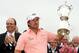 PEBBLE BEACH, CA - JUNE 20: Graeme McDowell (R) of Northern Ireland celebrates with the trophy on the 18th green after winning the 110th U.S. Open at Pebble Beach Golf Links on June 20, 2010 in Pebble Beach, California. (Photo by Ross Kinnaird/Getty Ima