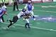 Jen Welter, carrying the ball, is the first woman to play a non-kicker position in a professional men's football league.