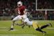 PALO ALTO, CA - NOVEMBER 30: Kevin Hogan #8 of the Stanford Cardinal gets tackled short of a first down by Matthias Farley #41 of the Notre Dame Fighting Irish during the third quarter at Stanford Stadium on November 30, 2013 in Palo Alto, California. (