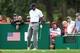 Oct 6, 2013; Dublin, OH, USA; Tiger Woods grabs his back after teeing off on the 18th hole during the fourth round of the Presidents Cup at Muirfield Village Golf Club. Mandatory Credit: Brian Spurlock-USA TODAY Sports