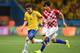 SAO PAULO, BRAZIL - JUNE 12: Oscar of Brazil dribbles toward the goal past Vedran Corluka of Croatia during the 2014 FIFA World Cup Brazil Group A match between Brazil and Croatia at Arena de Sao Paulo on June 12, 2014 in Sao Paulo, Brazil. (Photo by Bu