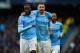 MANCHESTER, ENGLAND - MARCH 22: Yaya Toure of Manchester City celebrates scoring his hat trick with Aleksandar Kolarov of Manchester City during the Barclays Premier League match between Manchester City and Fulham at Etihad Stadium on March 22, 2014 in M