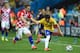 SAO PAULO, BRAZIL - JUNE 12: Luka Modric of Croatia closes down Bernard of Brazil during the 2014 FIFA World Cup Brazil Group A match between Brazil and Croatia at Arena de Sao Paulo on June 12, 2014 in Sao Paulo, Brazil. (Photo by Buda Mendes/Getty Ima