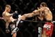 SINGAPORE - JANUARY 04: Tae Hyun Bang (L) kicks Mairbek Taisumov during their UFC Fight Night Singapore lightweight bout at Marina Bay Sands on January 4, 2014 in Singapore. (Photo by Suhaimi Abdullah/Getty Images)