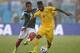 NATAL, BRAZIL - JUNE 13: Alex Song of Cameroon controls the ball as Giovani dos Santos of Mexico challenges during the 2014 FIFA World Cup Brazil Group A match between Mexico and Cameroon at Estadio das Dunas on June 13, 2014 in Natal, Brazil. (Photo by