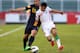 MUSCAT, OMAN - JANUARY 14: Petros Skapetis (L) of Australia competes for the ball with Eshan Pahlavan of Iran during the AFC U-22 Championship Group C match between Iran and Australia at Royal Oman Police Stadium on January 14, 2014 in Muscat, Oman. (Ph