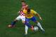 SAO PAULO, BRAZIL - JUNE 12: Hulk of Brazil fights off a challenge by Darijo Srna of Croatia during the 2014 FIFA World Cup Brazil Group A match between Brazil and Croatia at Arena de Sao Paulo on June 12, 2014 in Sao Paulo, Brazil. (Photo by Elsa/Getty