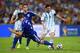 RIO DE JANEIRO, BRAZIL - JUNE 15: Lionel Messi of Argentina controls the ball on his way to scoring his team's second goal against Ermin Bicakcic (L) and Muhamed Besic of Bosnia and Herzegovina during the 2014 FIFA World Cup Brazil Group F match between