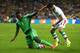 CURITIBA, BRAZIL - JUNE 16: Emmanuel Emenike of Nigeria and Alireza Jahan Bakhsh of Iran battle for the ball during the 2014 FIFA World Cup Brazil Group F match between Iran and Nigeria at Arena da Baixada on June 16, 2014 in Curitiba, Brazil. (Photo by