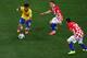 SAO PAULO, BRAZIL - JUNE 12: Neymar of Brazil controls the ball as Luka Modric and Mateo Kovacic (R) of Croatia and during the 2014 FIFA World Cup Brazil Group A match between Brazil and Croatia at Arena de Sao Paulo on June 12, 2014 in Sao Paulo, Brazi