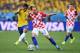 SAO PAULO, BRAZIL - JUNE 12: Ivan Rakitic of Croatia challenges Paulinho of Brazil in the first half during the 2014 FIFA World Cup Brazil Group A match between Brazil and Croatia at Arena de Sao Paulo on June 12, 2014 in Sao Paulo, Brazil. (Photo by Bud