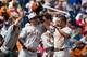 Jun 16, 2014; Omaha, NE, USA; Texas Longhorns pitcher Ty Marlow (48) greets infielder C.J. Hinojosa (9) after scoring against the Louisville Cardinals during game five of the 2014 College World Series at TD Ameritrade Park Omaha. Texas defeated Louisvill