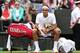 LONDON, ENGLAND - JUNE 24: Roger Federer of Switzerland takes a break during his gentlemen's singles first round match against Victor Hanescu of Romania on day one of the Wimbledon Lawn Tennis Championships at the All England Lawn Tennis and Croquet Club