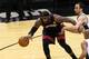 SAN ANTONIO, TX - JUNE 15: LeBron James #6 of the Miami Heat keeps the ball away from Manu Ginobili #20 of the San Antonio Spurs in Game Five of the 2014 NBA Finals at the AT&T Center on June 15, 2014 in San Antonio, Texas. NOTE TO USER: User expressly a