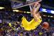 INDIANAPOLIS, IN - MARCH 30: Nik Stauskas #11 of the Michigan Wolverines dunks the ball over Dominique Hawkins #25 of the Kentucky Wildcats in the second half during the midwest regional final of the 2014 NCAA Men's Basketball Tournament at Lucas Oil Sta
