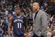 Holiday stands with Pelicans head coach Monty Williams.
