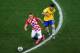 SAO PAULO, BRAZIL - JUNE 12: Oscar of Brazil challenges Luka Modric of Croatia during the 2014 FIFA World Cup Brazil Group A match between Brazil and Croatia at Arena de Sao Paulo on June 12, 2014 in Sao Paulo, Brazil. (Photo by Elsa/Getty Images)