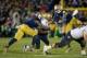 Nov 2, 2013; South Bend, IN, USA; Navy Midshipmen wide receiver Shawn Lynch (87) is tackled by Notre Dame Fighting Irish linebacker Jaylon Smith (9) and cornerback Bennett Jackson (2) in the fourth quarter at Notre Dame Stadium. Notre Dame won 38-34. Mand