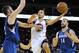 November 24, 2012; Oakland, CA, USA; Golden State Warriors shooting guard Stephen Curry (30) shoots the ball between Minnesota Timberwolves power forward Kevin Love (42, left) and center Nikola Pekovic (14) during the fourth quarter at ORACLE Arena. The W