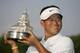 UNITED STATES - JULY 08: K.J. Choi with the championship trophy after winning the AT&T National at Congressional Country Club on July 8, 2007 in Bethesda, Maryland. (Photo by Hunter Martin/Getty Images)