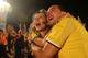 RIO DE JANEIRO, BRAZIL - JUNE 24: Colombia supporters embrace and celebrate after they defeated Japan while watching at the FIFA Fan Fest on Copacabana Beach on June 24, 2014 in Rio de Janeiro, Brazil. (Photo by Mario Tama/Getty Images)