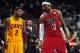Feb 24, 2013; Miami, FL, USA; Cleveland Cavaliers point guard Kyrie Irving (left) looks over at Miami Heat small forward LeBron James (right) as Cleveland Cavaliers head coach Byron Scott (center) looks on during the second half at the American Airlines A