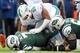 Dec 1, 2013; East Rutherford, NJ, USA; New York Jets quarterback Geno Smith (7) is sacked by Miami Dolphins defensive end Olivier Vernon (50) during the first quarter of a game at MetLife Stadium. Mandatory Credit: Brad Penner-USA TODAY Sports