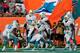 MIAMI GARDENS, FL - DECEMBER 15: Marcus Thigpen #34 of the Miami Dolphins celebrates his touchdown in the fourth quarter with teammates Ryan Tannehill #17 of the Miami Dolphins and Lamar Miller #26 of the Miami Dolphins against the New England Patriots