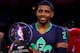 NEW ORLEANS, LA - FEBRUARY 16: The Eastern Conference's Kyrie Irving #2 of the Cleveland Cavaliers celebrates with the Kia NBA All-Star Game MVP trophy after the 2014 NBA All-Star game at the Smoothie King Center on February 16, 2014 in New Orleans, Loui