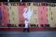 LIVERPOOL, ENGLAND - APRIL 15: A woman walks past a Hillsborough tribute banner as fans arrive in Anfield for a memorial service marking the 25th anniversary of the Hillsborough Disaster at Anfield stadium on April 15, 2014 in Liverpool, England. Thousan