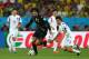 SAO PAULO, BRAZIL - JUNE 26: Marouane Fellaini of Belgium and Koo Ja-Cheol of South Korea compete for the ball during the 2014 FIFA World Cup Brazil Group H match between South Korea and Belgium at Arena de Sao Paulo on June 26, 2014 in Sao Paulo, Brazil