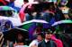 LONDON, ENGLAND - JUNE 30: G4s Security out in the rain remain in good humor as fans sitting on Murray mound shelter under umbrellas as they watch the Andy Murray against Kevin Anderson game on the big screen on day seven of the Wimbledon Lawn Tennis Cha