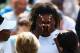 LONDON, ENGLAND - JULY 01: Serena Williams of the United States recieves treatment during the warm up before their Ladies Doubles second round match with Venus Williams (l) against Kristina Barrois of Germany and Stefanie Voegele of Switzerland on day ei