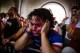 NEW YORK, NY - JULY 01: Christian Raja, of Brooklyn, reacts at a missed attempt on goal by the United during overtime against Belgium in the World Cup while watching on a projected screen under the Manhattan Bridge on July 1, 2014 in the Dumbo neighborho