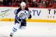 CALGARY, AB - APRIL 11: Olli Jokinen #12 of the Winnipeg Jets skates against the Calgary Flames at Scotiabank Saddledome on April 11, 2014 in Calgary, Alberta, Canada. The Jets won 4-3. (Photo by Gerry Thomas/NHLI via Getty Images)