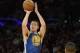 Apr 11, 2014; Los Angeles, CA, USA; Golden State Warriors guard Klay Thompson (11) shoots as Los Angeles Lakers forward Wesley Johnson (11) looks on at Staples Center. Mandatory Credit: Richard Mackson-USA TODAY Sports
