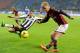 MILAN, ITALY - JANUARY 22: Keisuke Honda of AC Milan (R) and Allan of Udinese Calcio compete for the ball during the TIM Cup match between AC Milan and Udinese Calcio at Stadio Giuseppe Meazza on January 22, 2014 in Milan, Italy. (Photo by Claudio Villa