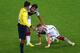 PORTO ALEGRE, BRAZIL - JUNE 30: Bastian Schweinsteiger of Germany kneels on the field as Sami Khedira and referee Sandro Ricci stand over during the 2014 FIFA World Cup Brazil Round of 16 match between Germany and Algeria at Estadio Beira-Rio on June 30,