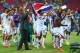 RECIFE, BRAZIL - JUNE 29: Yeltsin Tejeda of Costa Rica holds up his countries flag in celebration with his teammates after defeating Greece in a penalty shootout during the 2014 FIFA World Cup Brazil Round of 16 match between Costa Rica and Greece at Aren