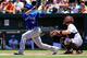 BALTIMORE, MD - JUNE 15: Catcher Nick Hundley #40 of the Baltimore Orioles looks on as Jose Bautista #19 of the Toronto Blue Jays follows his RBI double during the first inning at Oriole Park at Camden Yards on June 15, 2014 in Baltimore, Maryland. (Phot