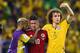 FORTALEZA, BRAZIL - JULY 04: Dani Alves (L) and David Luiz of Brazil console James Rodriguez of Colombia after Brazil's 2-1 win during the 2014 FIFA World Cup Brazil Quarter Final match between Brazil and Colombia at Castelao on July 4, 2014 in Fortaleza