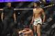 Jan 25, 2014; Chicago, IL, USA; Alex Caceres (red gloves) walks away after beating Sergio Pettis (blue gloves) in a fight during UFC on FOX 10 at the United Center. Mandatory Credit: David Banks-USA TODAY Sports