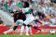 ELCHE, SPAIN - MAY 11: Marc Bartra of FC Barcelona is brought down by Carlos Sanchez and Richmond Boakye of Elche FC during the La Liga match between Elche FC and FC Barcelona at Estadio Manuel Martinez Valero on May 11, 2014 in Elche, Spain. (Photo by