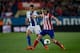 MADRID, SPAIN - MARCH 15: Filipe Luis (R) of Atletico de Madrid competes for the ball with Cristhian Stuani (L) of RCD Espanyol during the La Liga match between Club Atletico de Madrid and RCD Espanyol at Vicente Calderon Stadium on March 15, 2014 in Madr